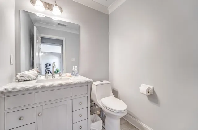 a bathroom with a sink a toilet and mirror