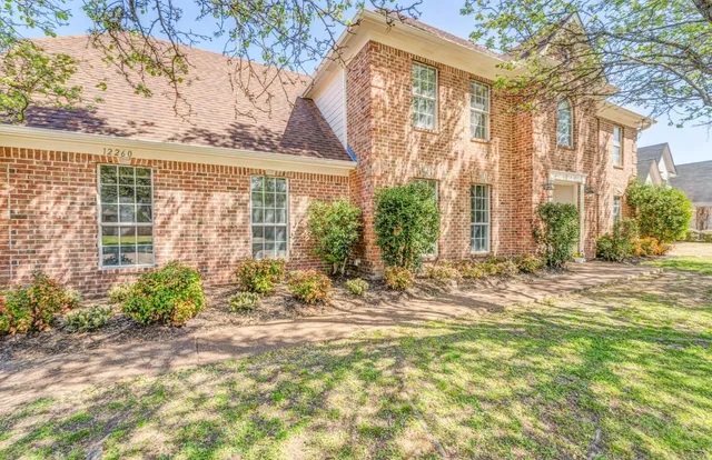 a view of a house with a yard and sitting area