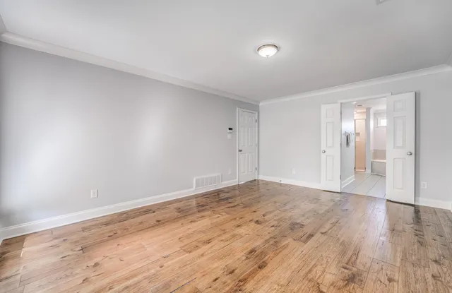 a view of an empty room and wooden floor