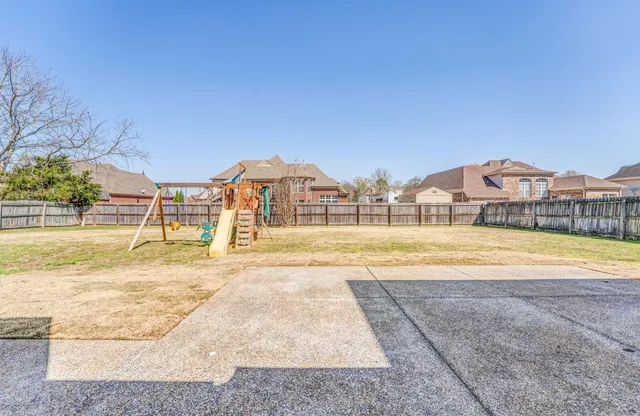 a view of swimming pool with a yard