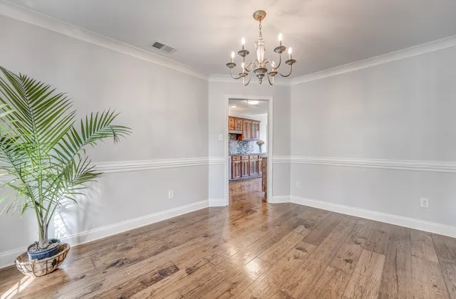 a view of a room with wooden floor and window