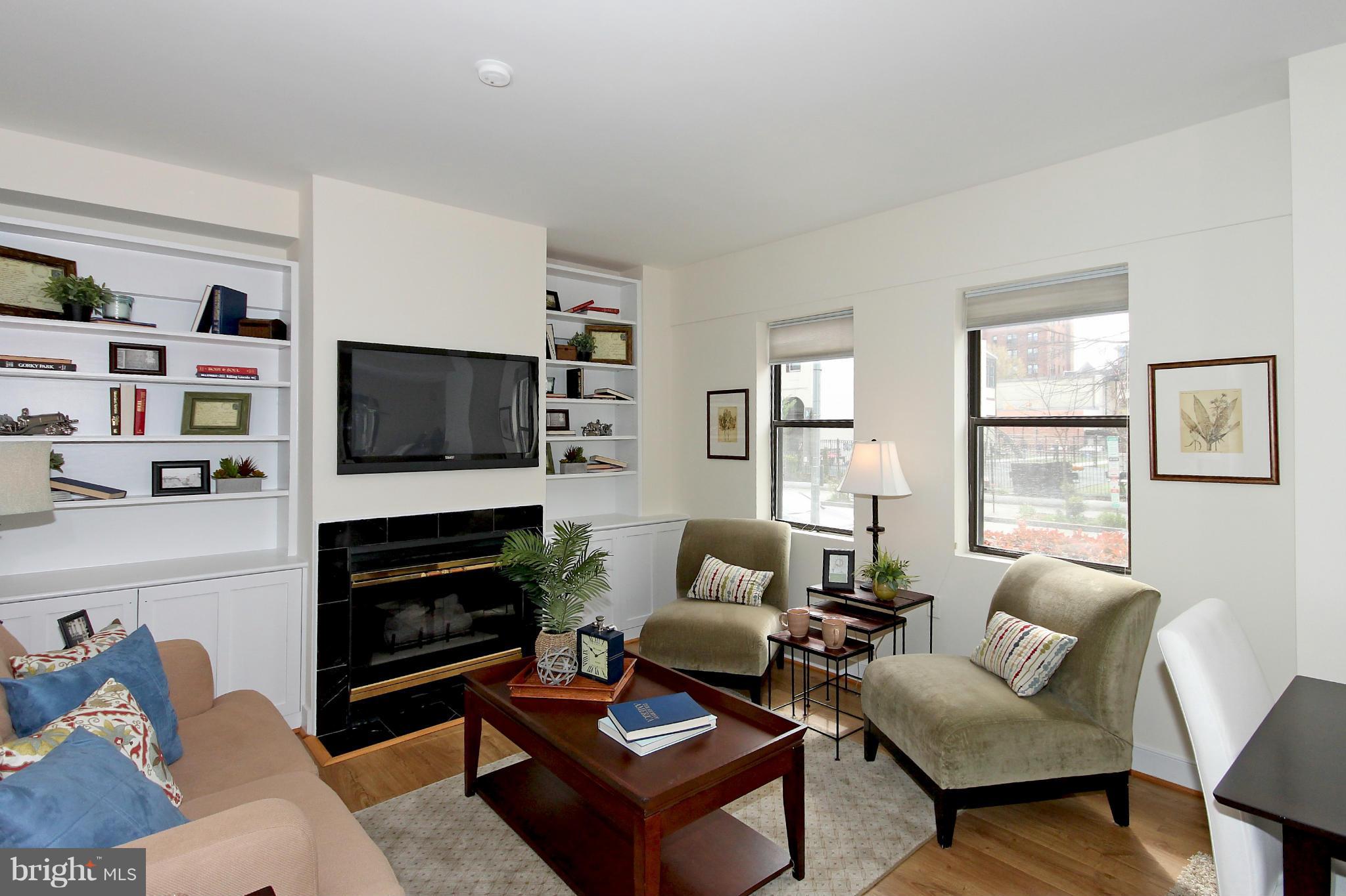 1727 R Street Northwest, Unit 101 Washington, DC 20009 - Photo 2 of 30 a living room with furniture flat screen tv and a fireplace