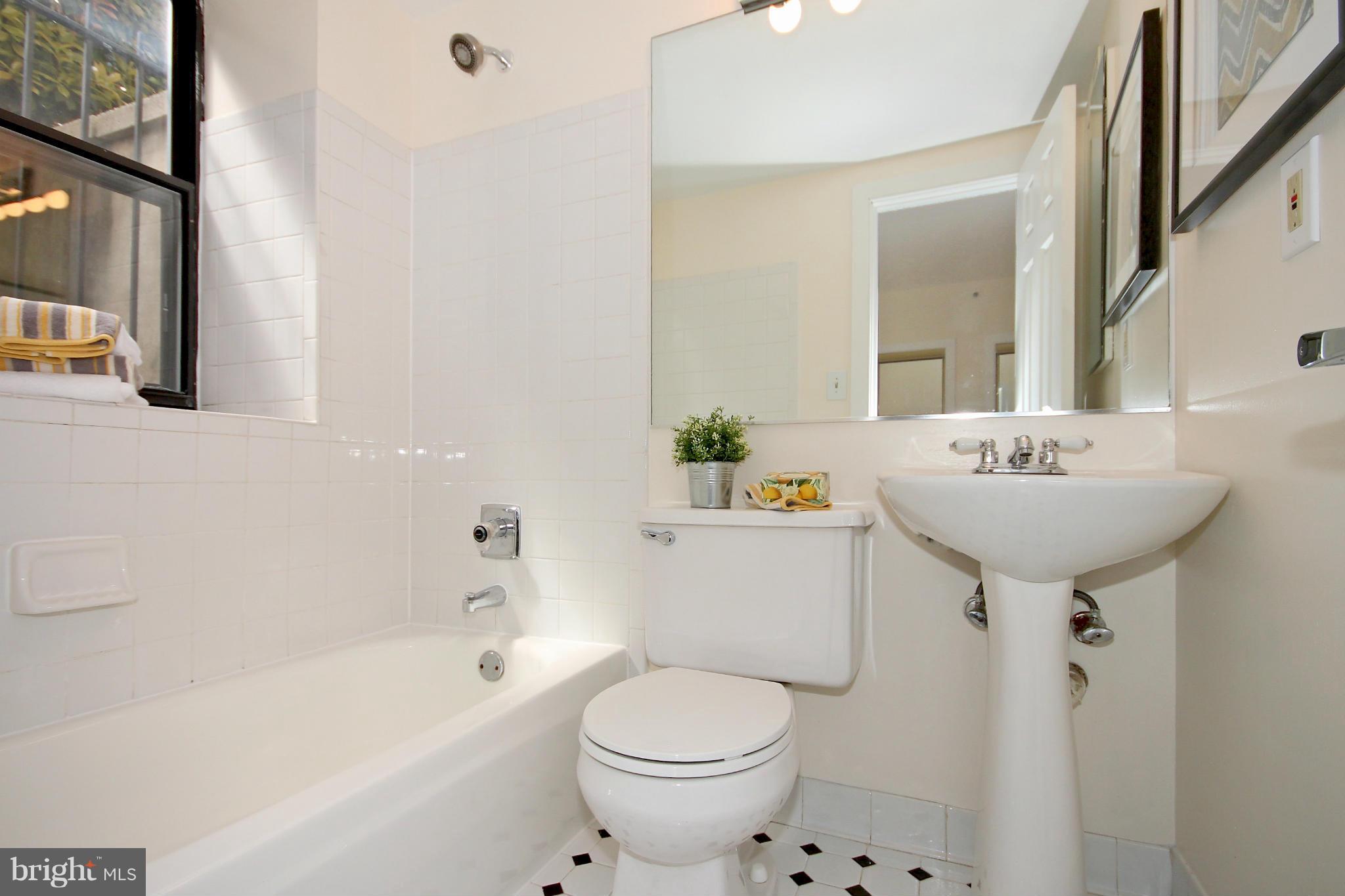 1727 R Street Northwest, Unit 101 Washington, DC 20009 - Photo 11 of 30 a bathroom with a sink toilet and shower