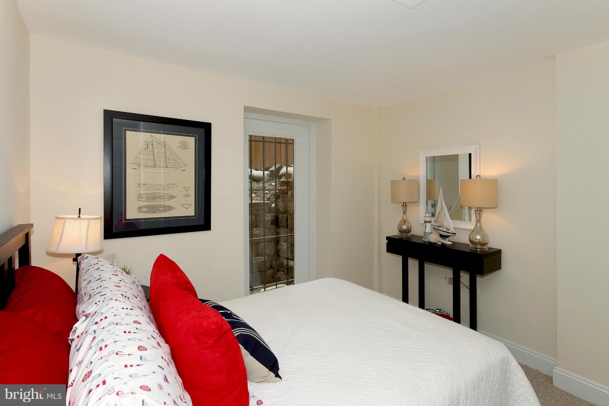 1727 R Street Northwest, Unit 101 Washington, DC 20009 - Photo 12 of 30 a bed room with a bed and a lamp