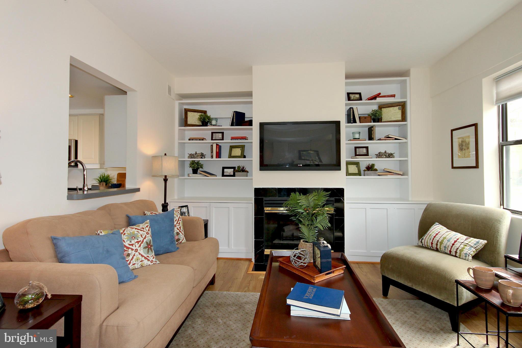 1727 R Street Northwest, Unit 101 Washington, DC 20009 - Photo 3 of 30 a living room with furniture a flat screen tv and a fireplace