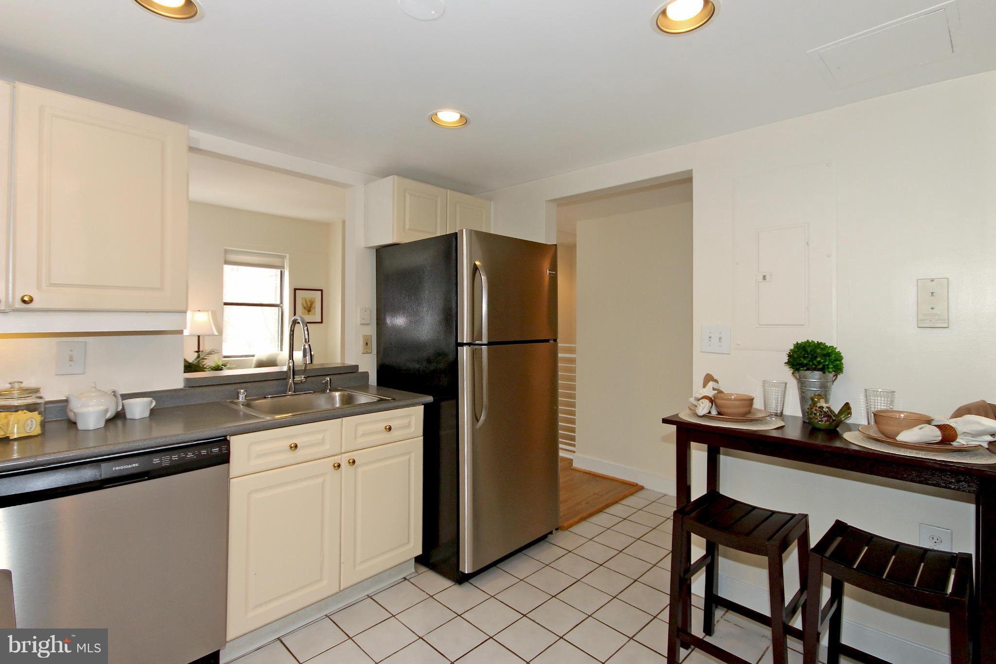 1727 R Street Northwest, Unit 101 Washington, DC 20009 - Photo 8 of 30 a kitchen with a dining table and chairs