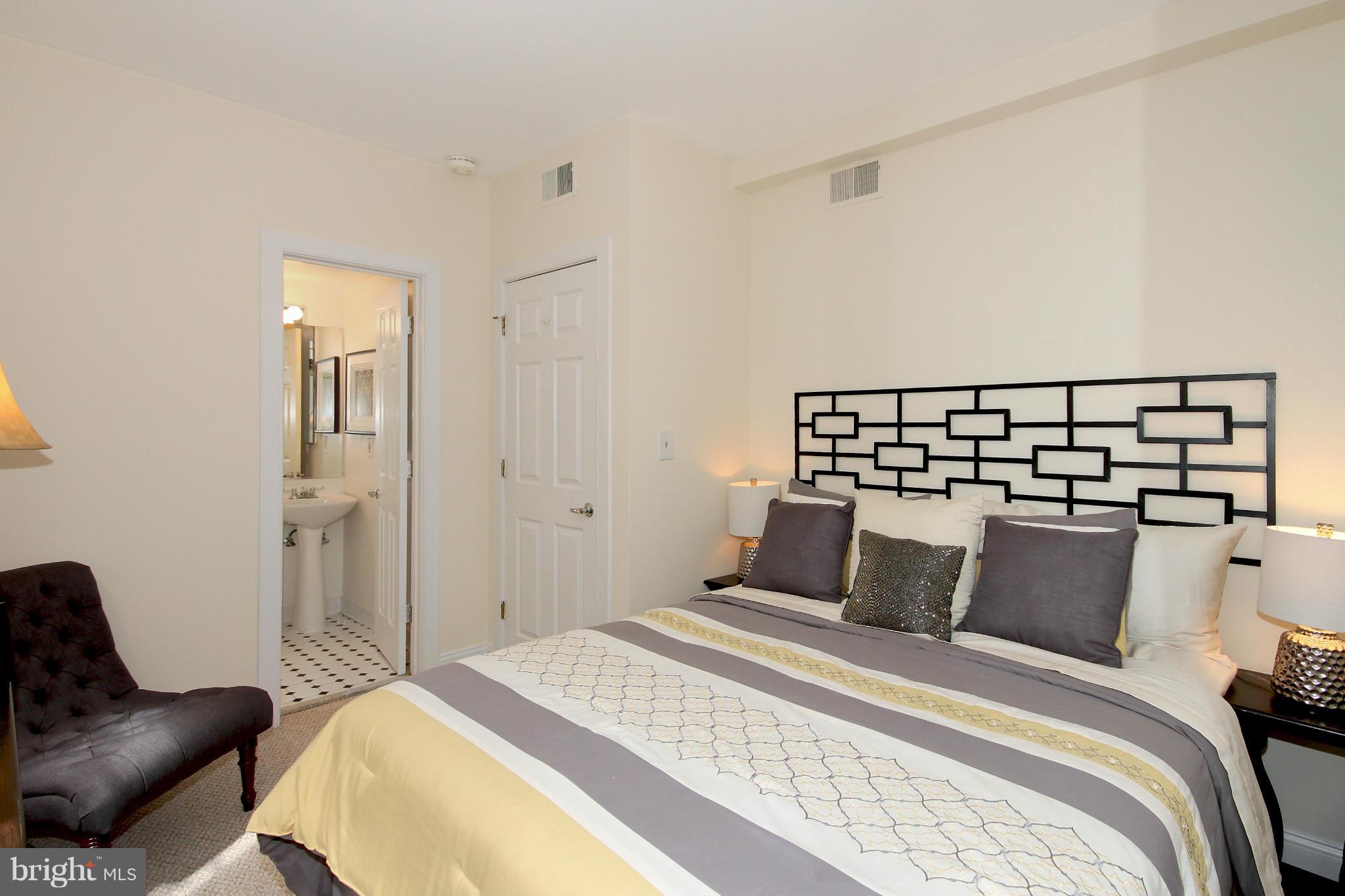 1727 R Street Northwest, Unit 101 Washington, DC 20009 - Photo 10 of 30 a bedroom with a bed and wooden floor