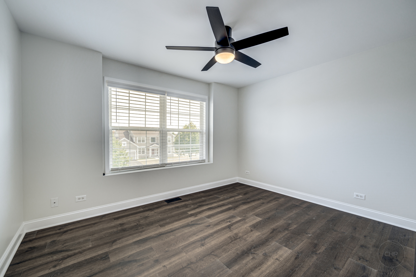 12948 Parterre Place Plainfield, IL 60585 - Photo 33 of 35 an empty room with wooden floor fan and windows