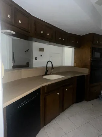 a kitchen with a sink and cabinets