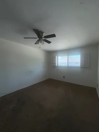 an empty room with a empty space and windows