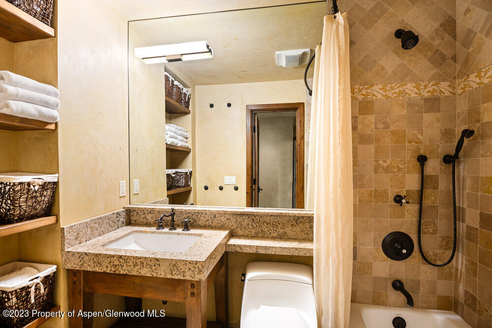 114 East Bleeker Street, Unit 102 Aspen, CO 81611 - Photo 14 of 21 a bathroom with a granite countertop shower and a sink