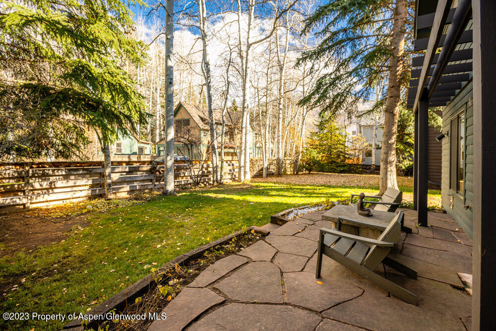 114 East Bleeker Street, Unit 102 Aspen, CO 81611 - Photo 16 of 21 a view of a swimming pool with lawn chairs under an umbrella