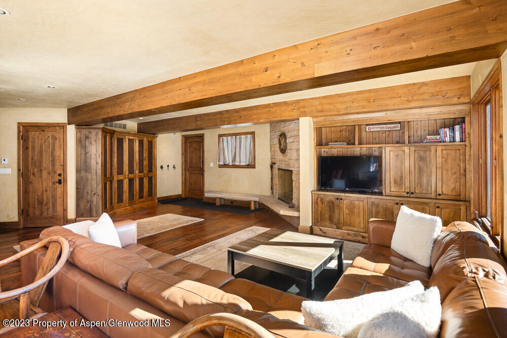 114 East Bleeker Street, Unit 102 Aspen, CO 81611 - Photo 5 of 21 a living room with furniture and a flat screen tv