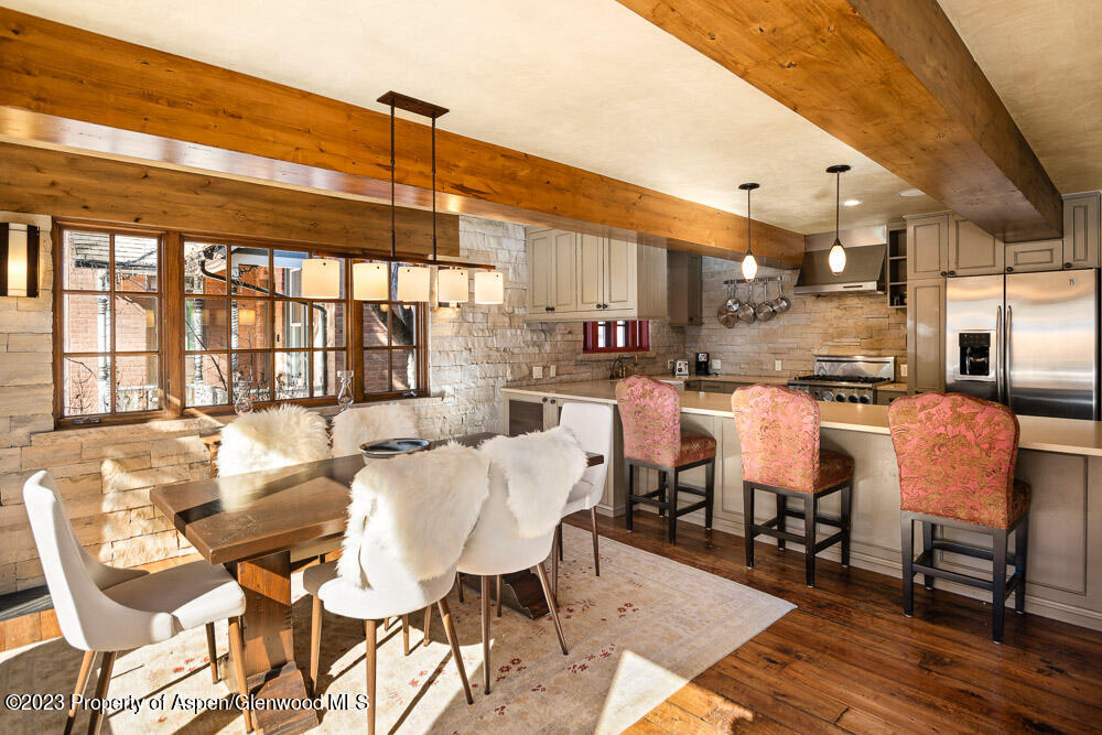 114 East Bleeker Street, Unit 102 Aspen, CO 81611 - Photo 6 of 21 a dining room with stainless steel appliances kitchen island granite countertop a table and chairs