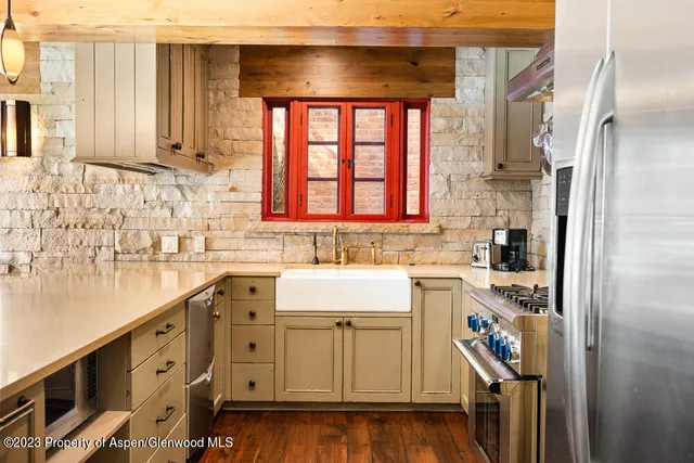 a kitchen with a refrigerator and a sink