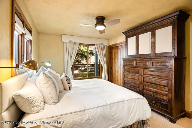 a bedroom with a large bed and a large window