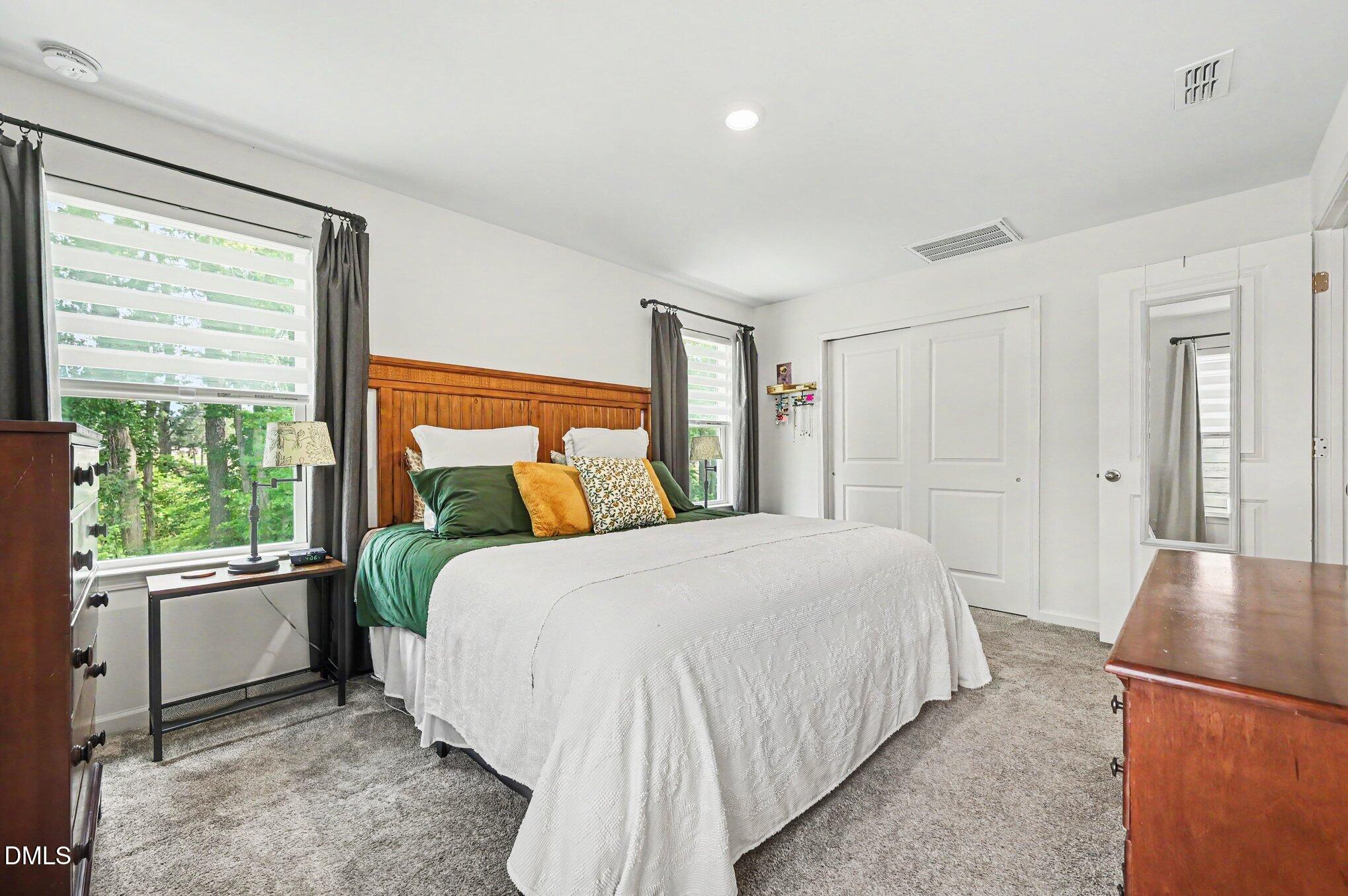 574 Hacksaw Trail Raleigh, NC 27610 - Photo 12 of 28 a bedroom with a large bed and windows