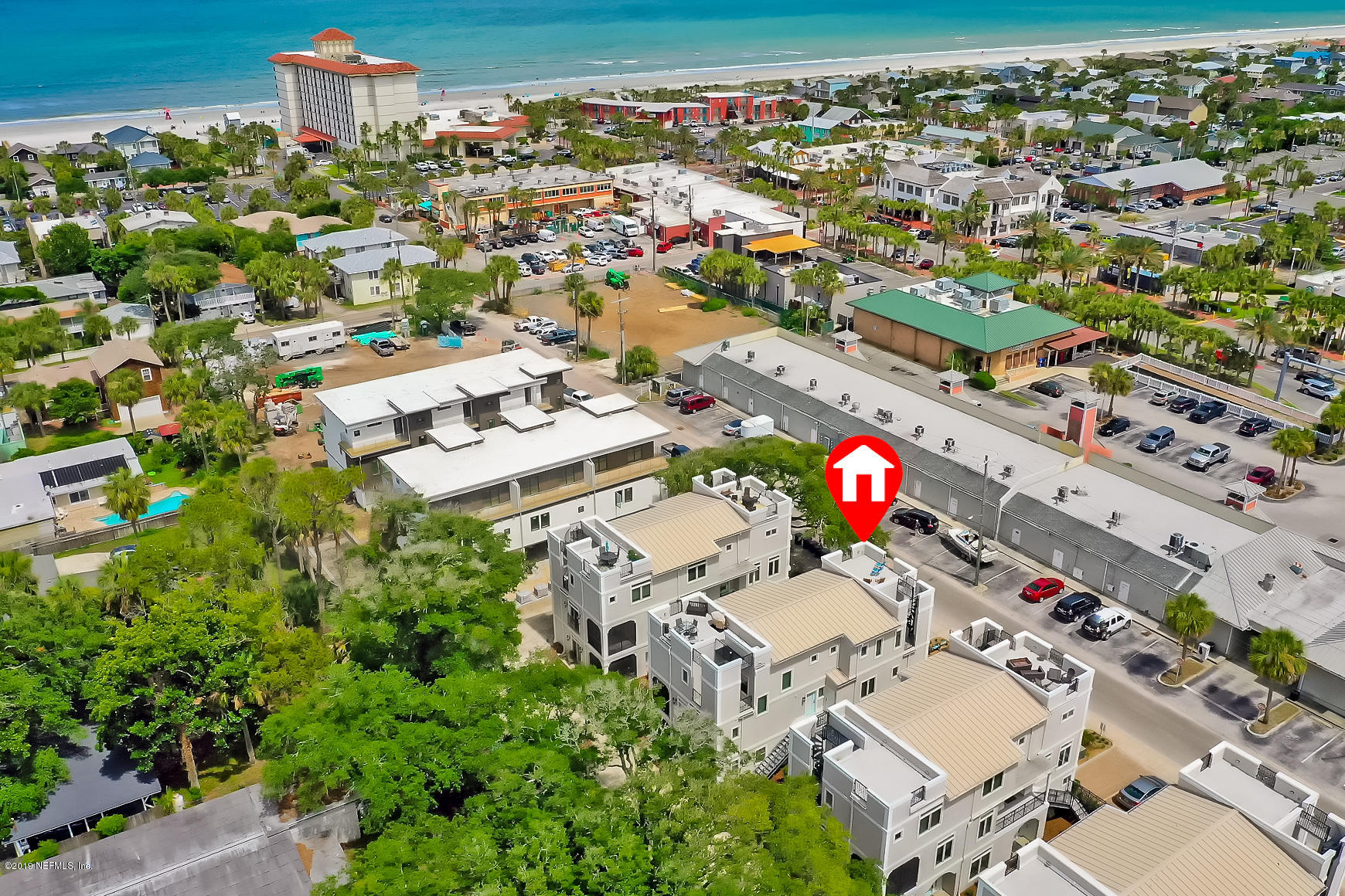an aerial view of residential houses with outdoor space
