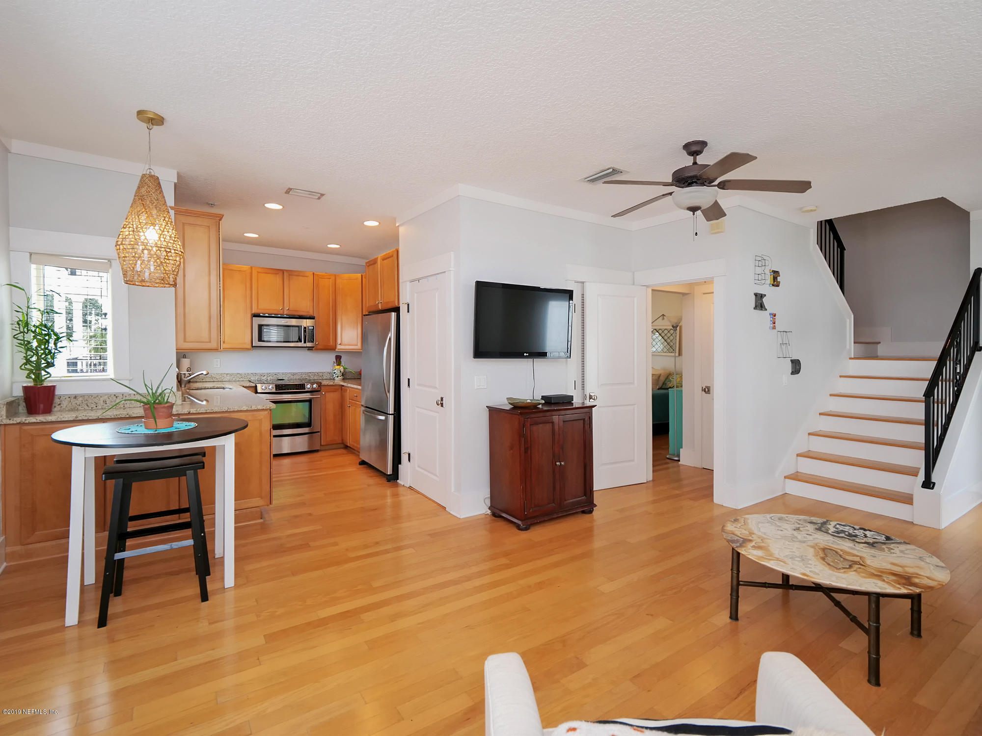 345 Ahern Street Atlantic Beach, FL 32233 - Photo 11 of 44 a living room with furniture a flat screen tv and kitchen view