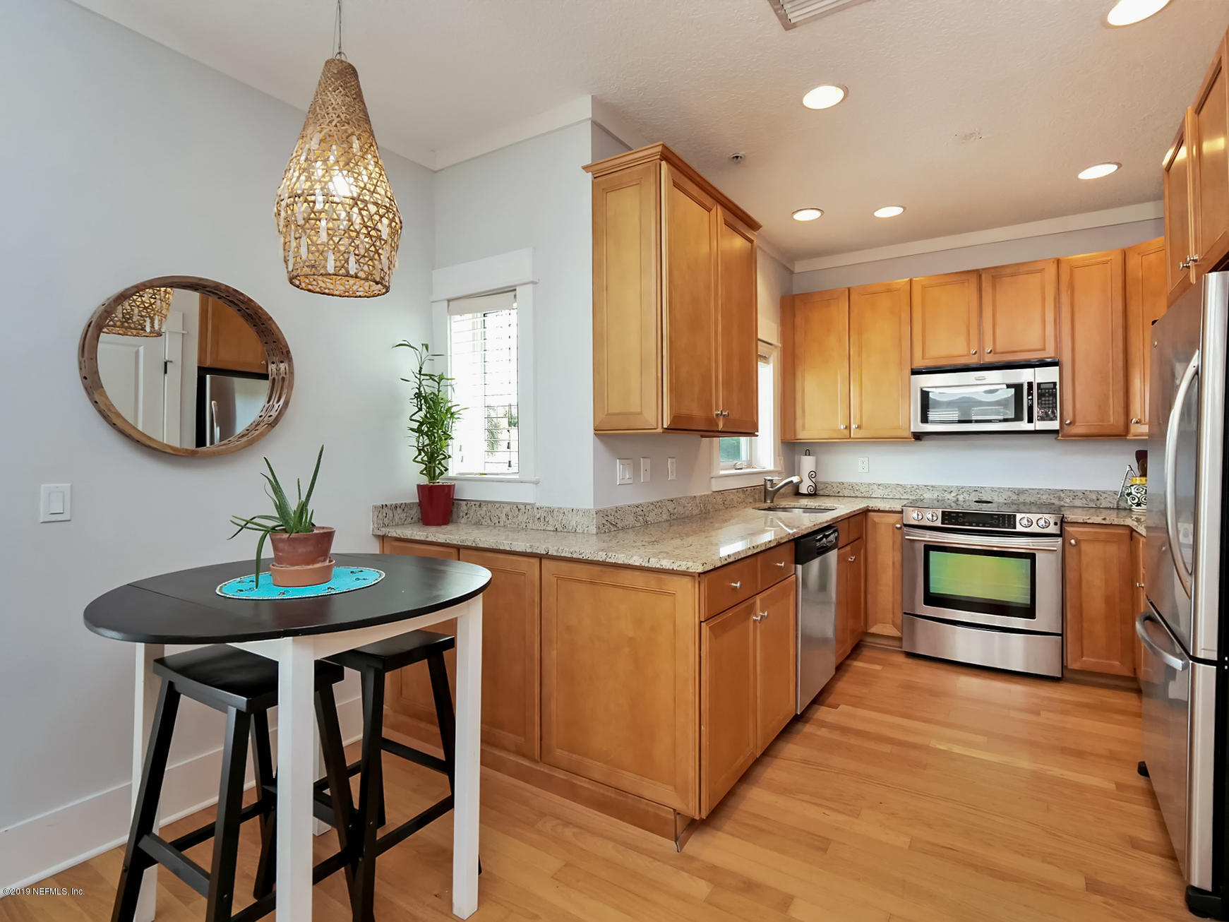 345 Ahern Street Atlantic Beach, FL 32233 - Photo 12 of 44 a kitchen with stainless steel appliances granite countertop a sink a stove a microwave a refrigerator and a stove