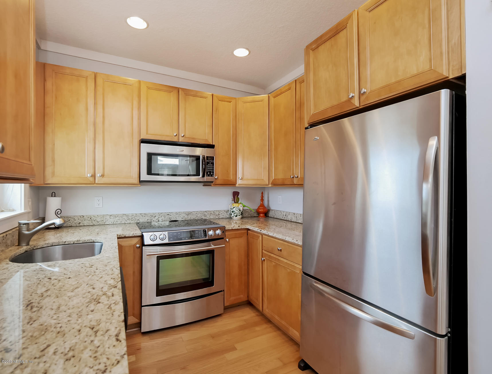 345 Ahern Street Atlantic Beach, FL 32233 - Photo 13 of 44 a kitchen with a refrigerator sink and microwave