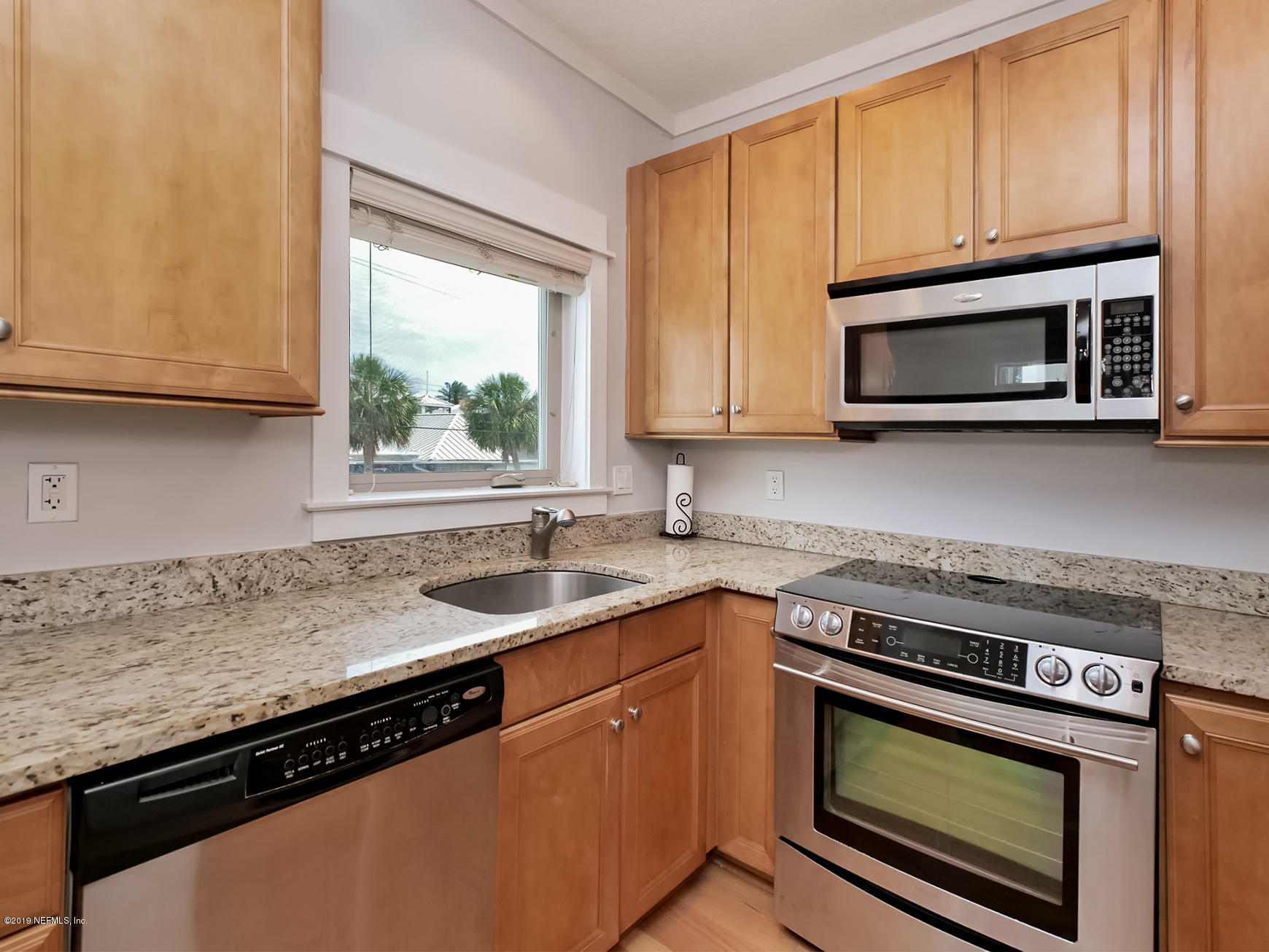 345 Ahern Street Atlantic Beach, FL 32233 - Photo 14 of 44 a kitchen with granite countertop a sink stove and microwave