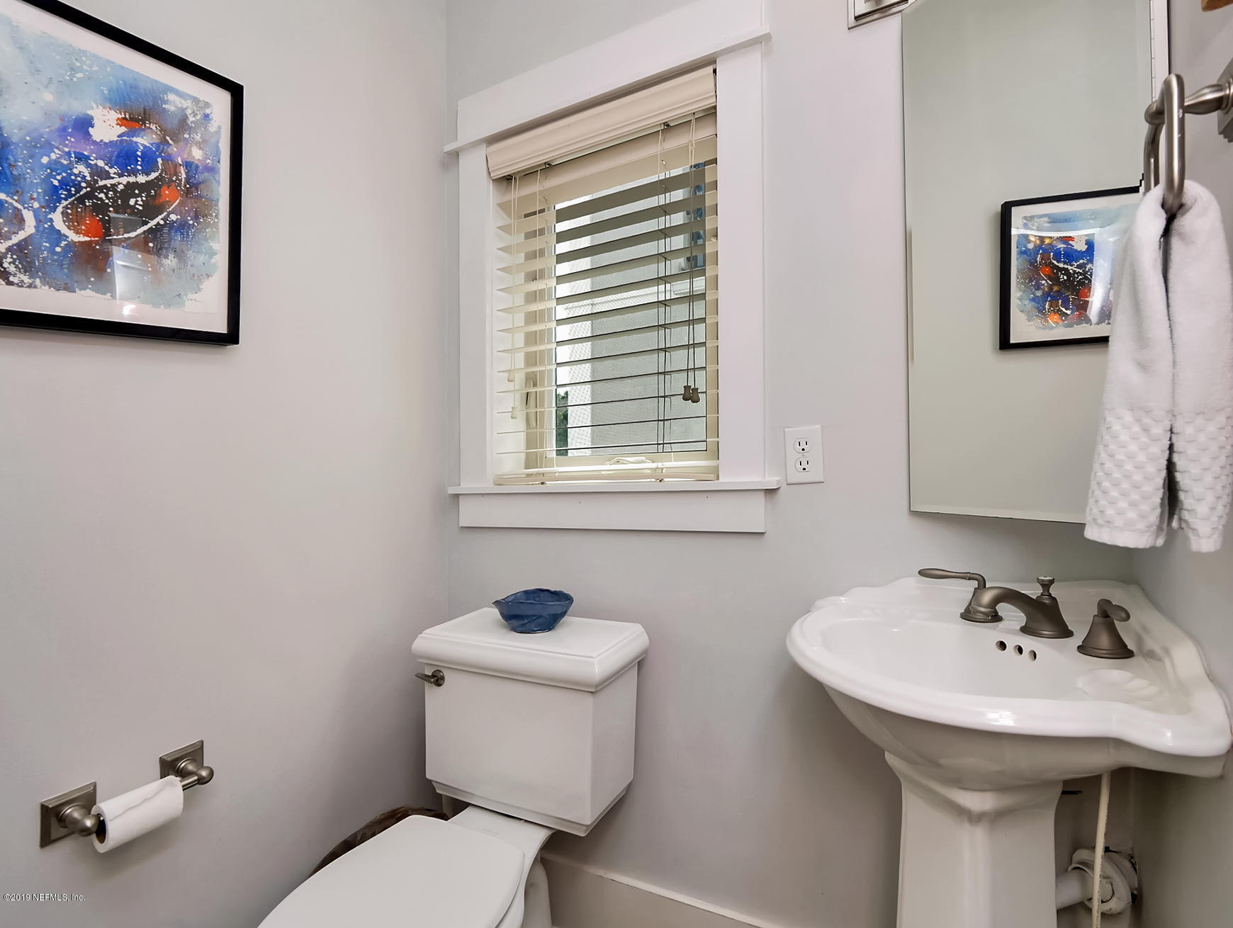 345 Ahern Street Atlantic Beach, FL 32233 - Photo 17 of 44 a bathroom with a toilet sink and mirror