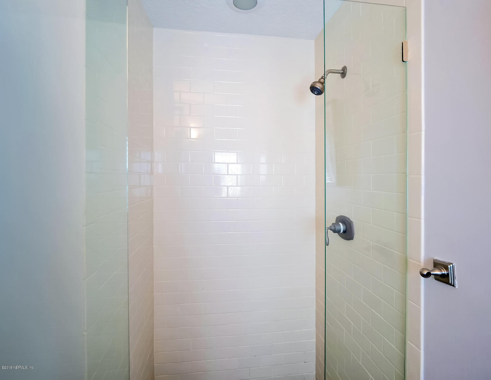 345 Ahern Street Atlantic Beach, FL 32233 - Photo 18 of 44 a bathroom with a glass shower door