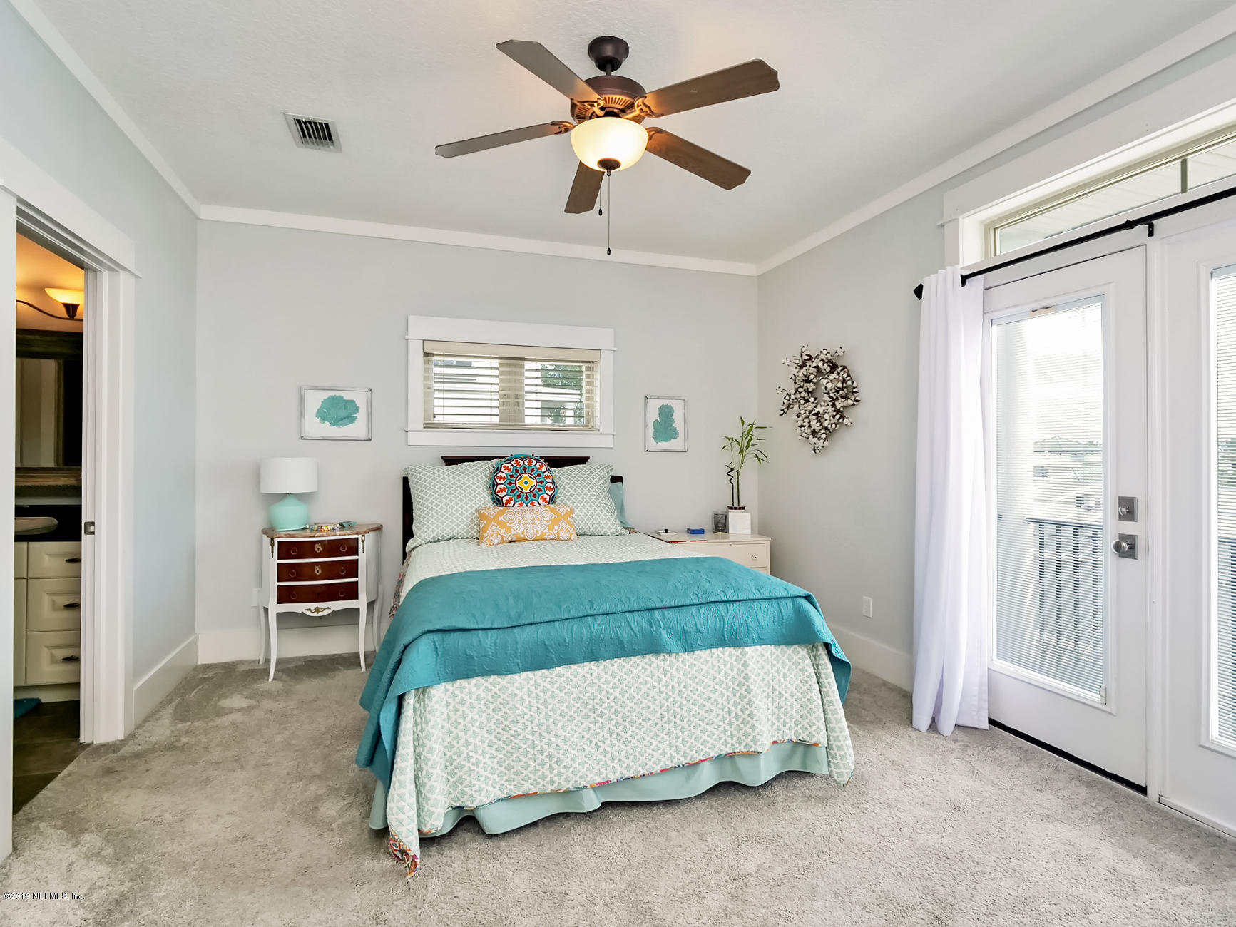 345 Ahern Street Atlantic Beach, FL 32233 - Photo 20 of 44 a bedroom with a bed and a chandelier