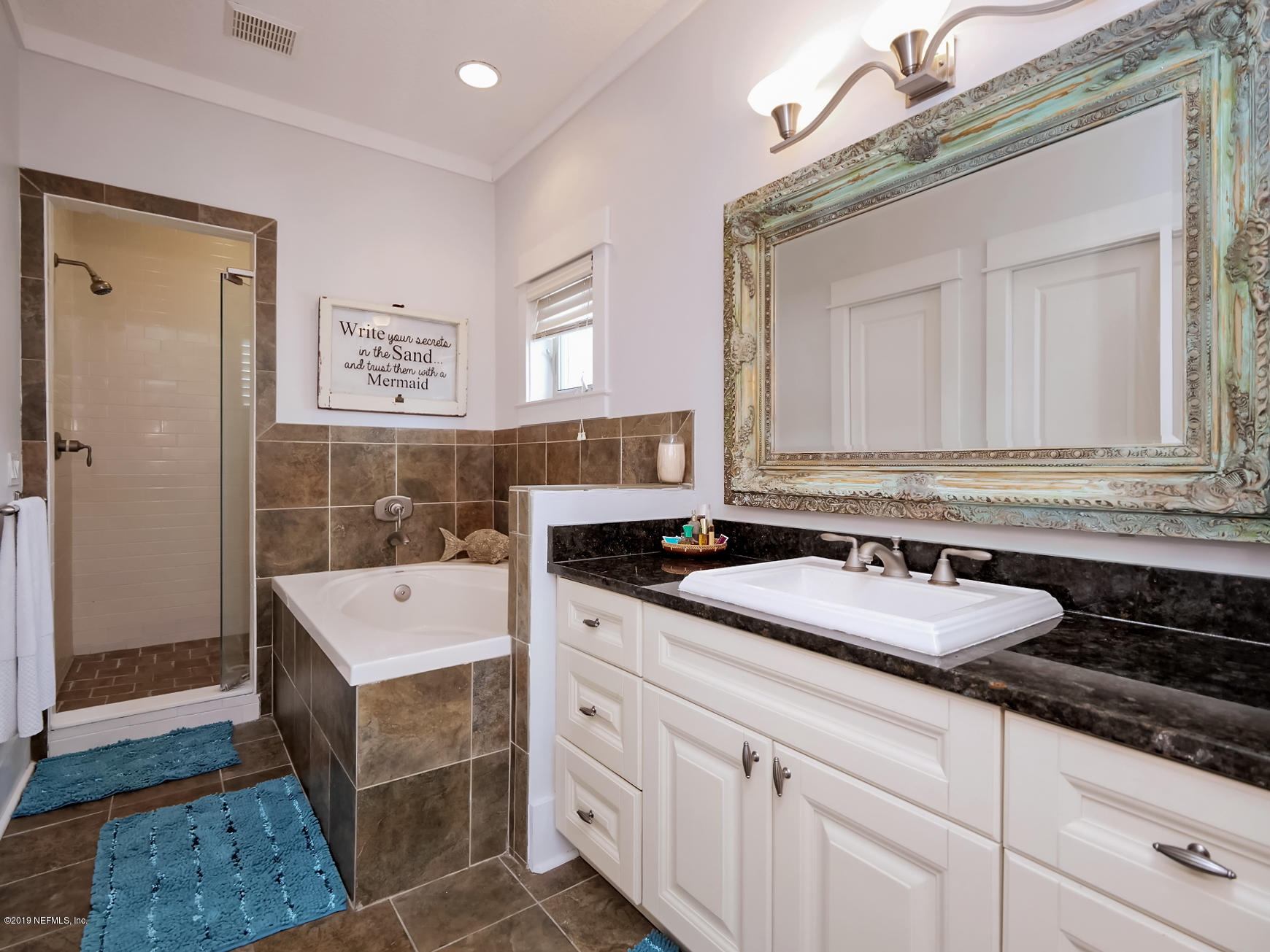 345 Ahern Street Atlantic Beach, FL 32233 - Photo 22 of 44 a bathroom with a sink and a mirror