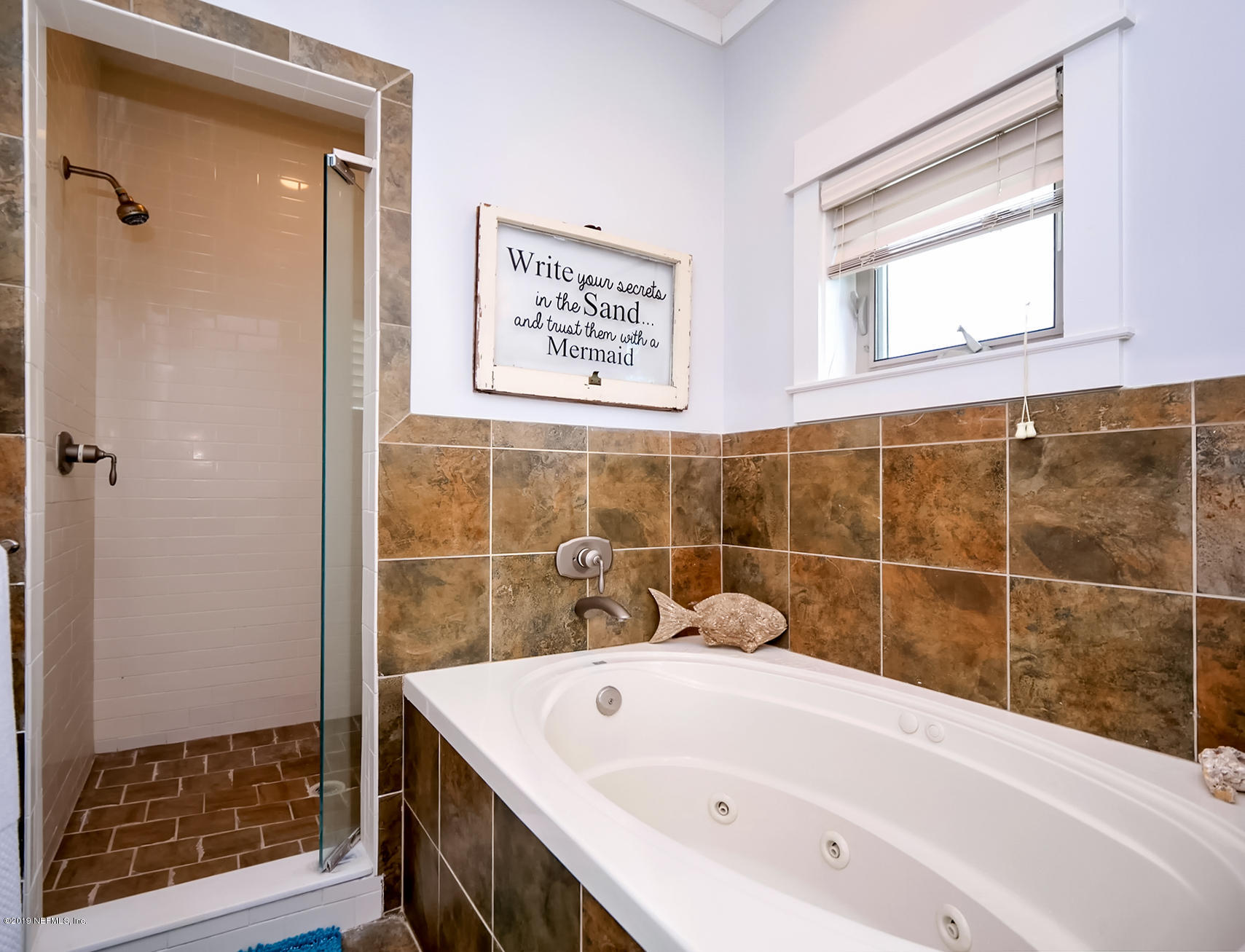 345 Ahern Street Atlantic Beach, FL 32233 - Photo 23 of 44 a bathroom with a tub a sink and a shower