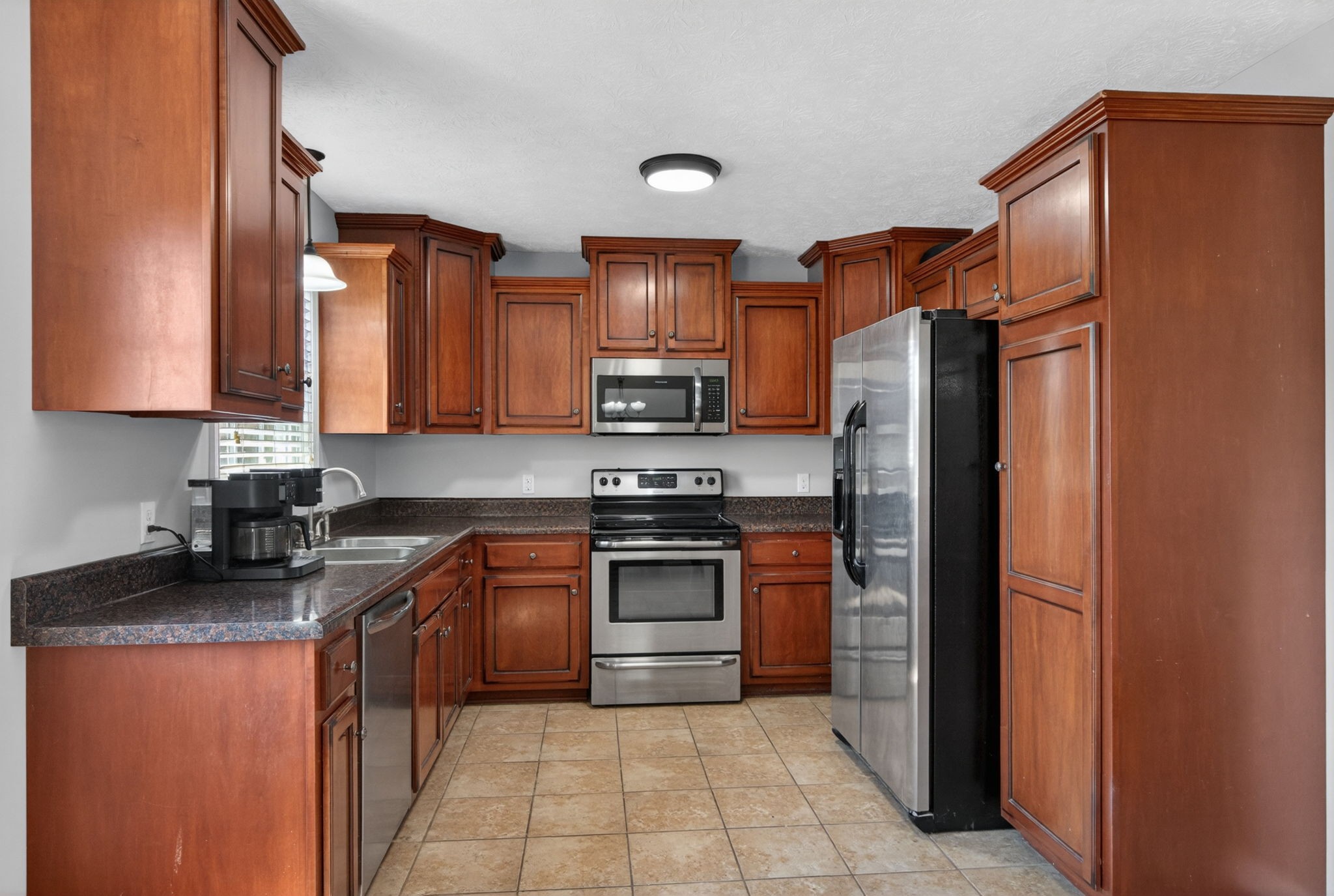 126 Hollands Way Portland, TN 37148 - Photo 19 of 42 a kitchen with stainless steel appliances granite countertop a refrigerator stove and sink