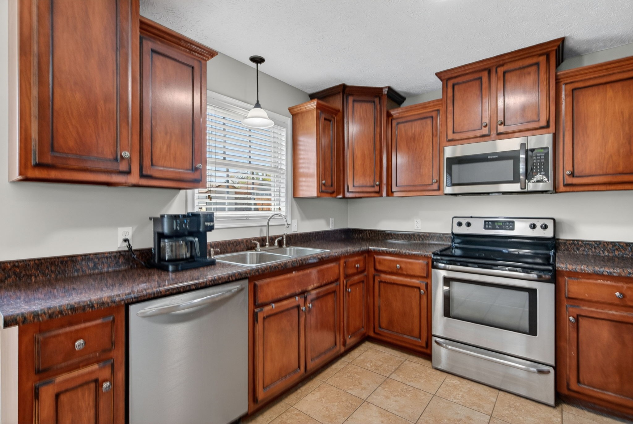 126 Hollands Way Portland, TN 37148 - Photo 21 of 42 a kitchen with granite countertop stainless steel appliances stove microwave and cabinets