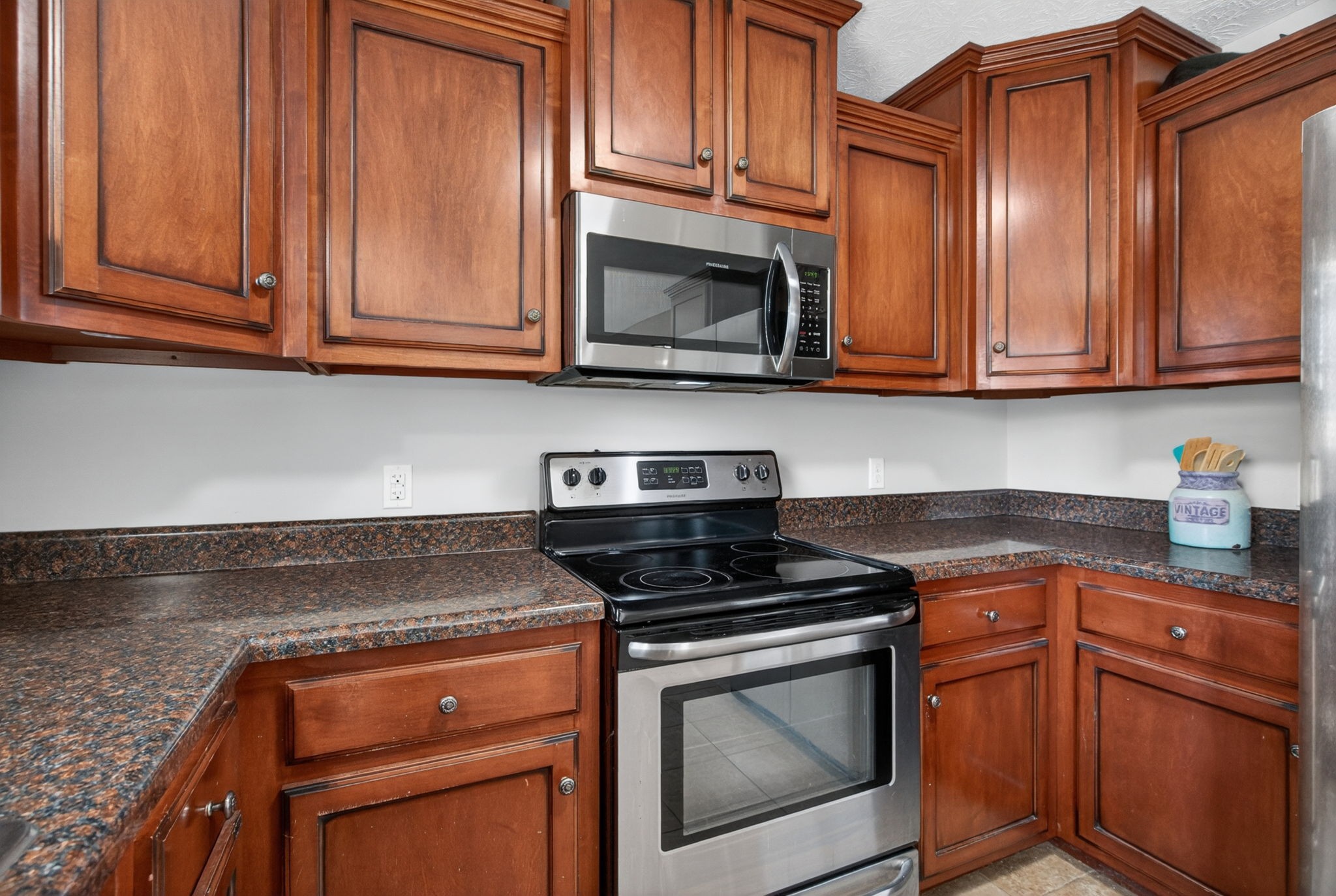 126 Hollands Way Portland, TN 37148 - Photo 23 of 42 a kitchen with granite countertop cabinets stainless steel appliances and a sink