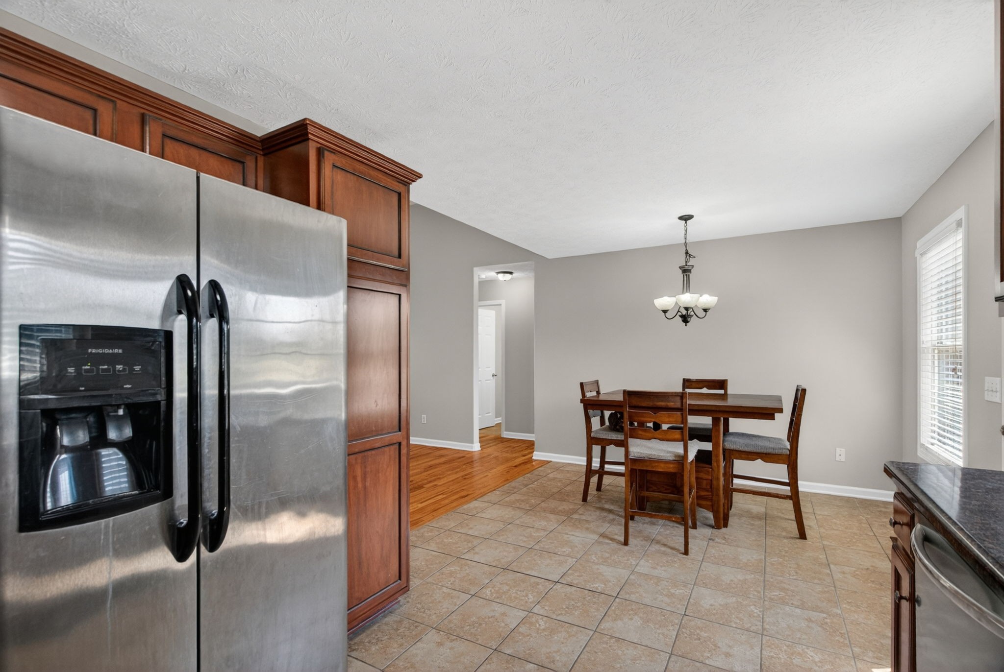 126 Hollands Way Portland, TN 37148 - Photo 24 of 42 a kitchen with stainless steel appliances kitchen island granite countertop dining table chair and a window
