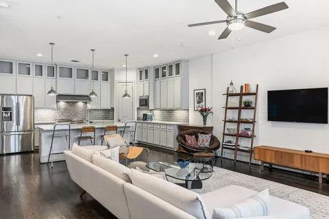 a kitchen with granite countertop white cabinets and white stove