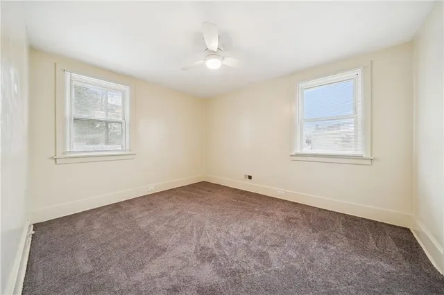 an empty room with windows and closet