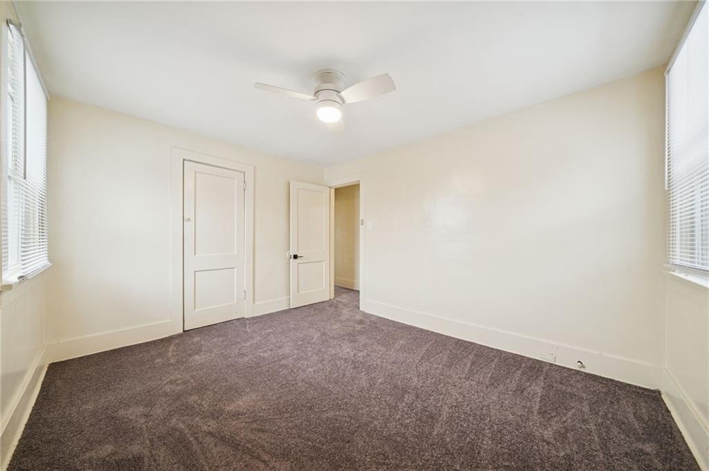400 Broadway Avenue McKees Rocks, PA 15136 - Photo 15 of 34 an empty room with a ceiling fan and a window