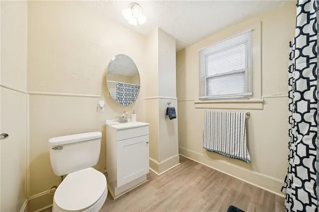 a bathroom with a toilet a sink and mirror