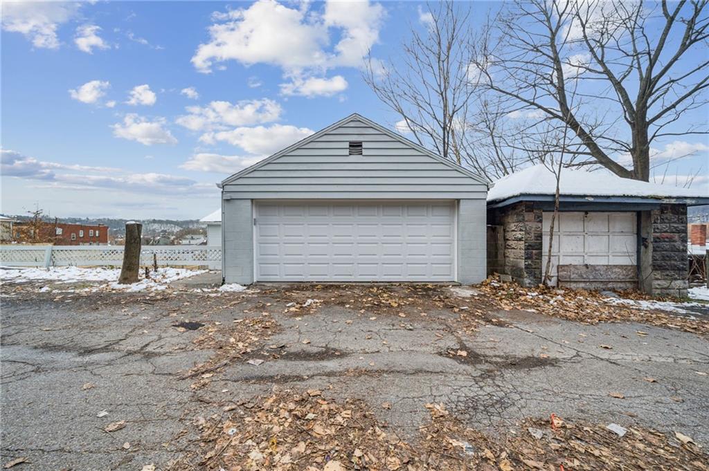 400 Broadway Avenue McKees Rocks, PA 15136 - Photo 2 of 34 a front view of a house with a yard and garage