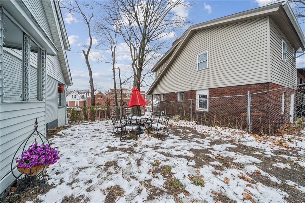 400 Broadway Avenue McKees Rocks, PA 15136 - Photo 31 of 34 a backyard of a house with large tree and wooden fence