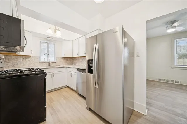 a kitchen with a refrigerator stove and sink