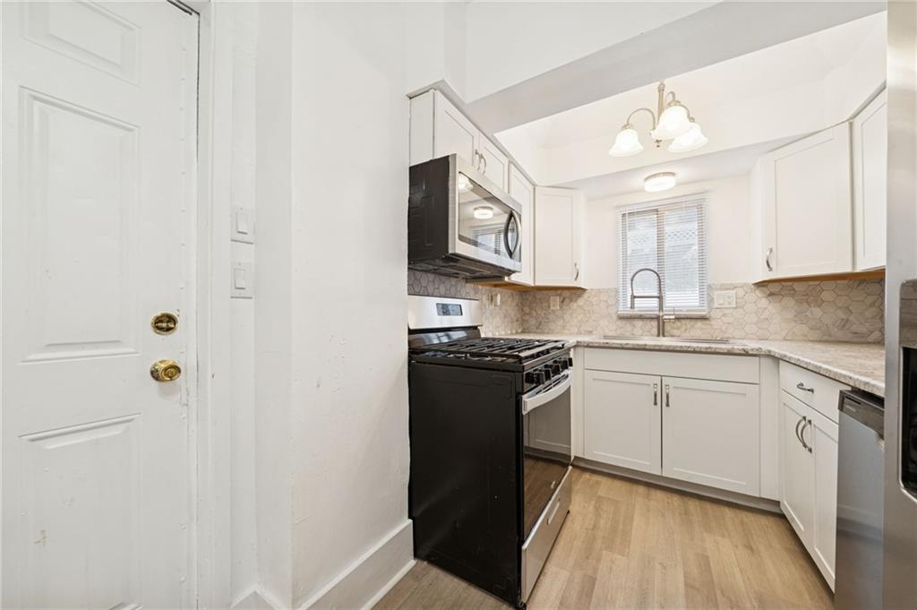 400 Broadway Avenue McKees Rocks, PA 15136 - Photo 8 of 34 a kitchen with stainless steel appliances granite countertop a stove a sink and a refrigerator