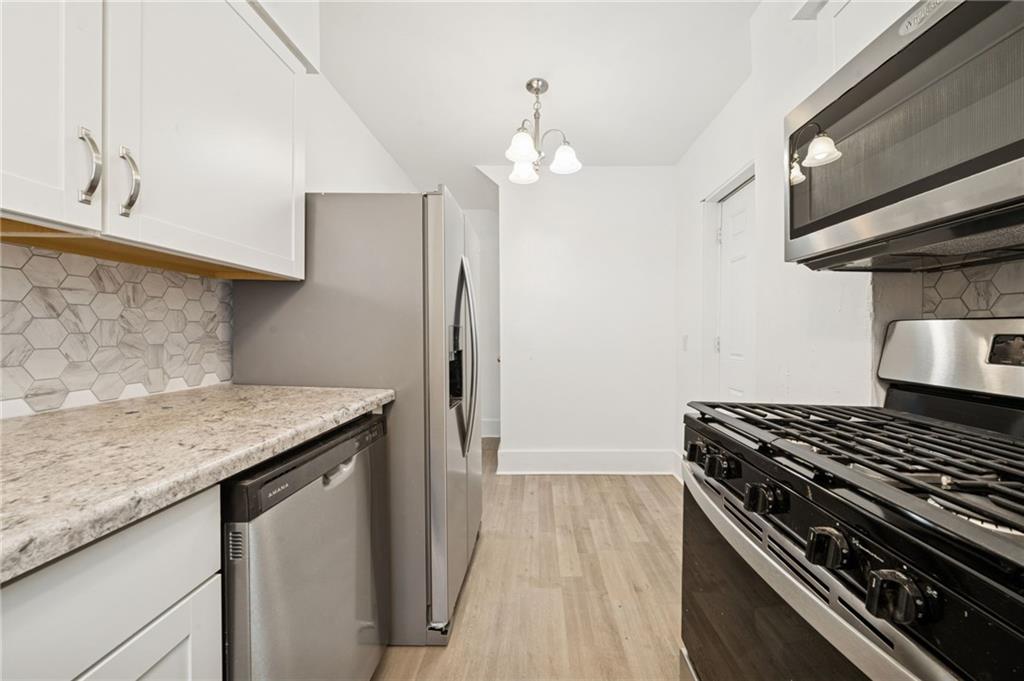 400 Broadway Avenue McKees Rocks, PA 15136 - Photo 9 of 34 a kitchen with stainless steel appliances granite countertop a stove and a refrigerator