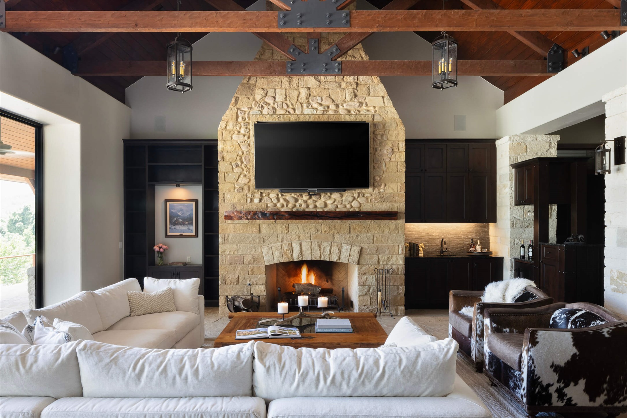 15016 Flat Top Ranch Road Austin, TX 78732 - Photo 2 of 40 Living room with high vaulted ceiling, a stone fireplace, and a wooden ceiling with exposed beams