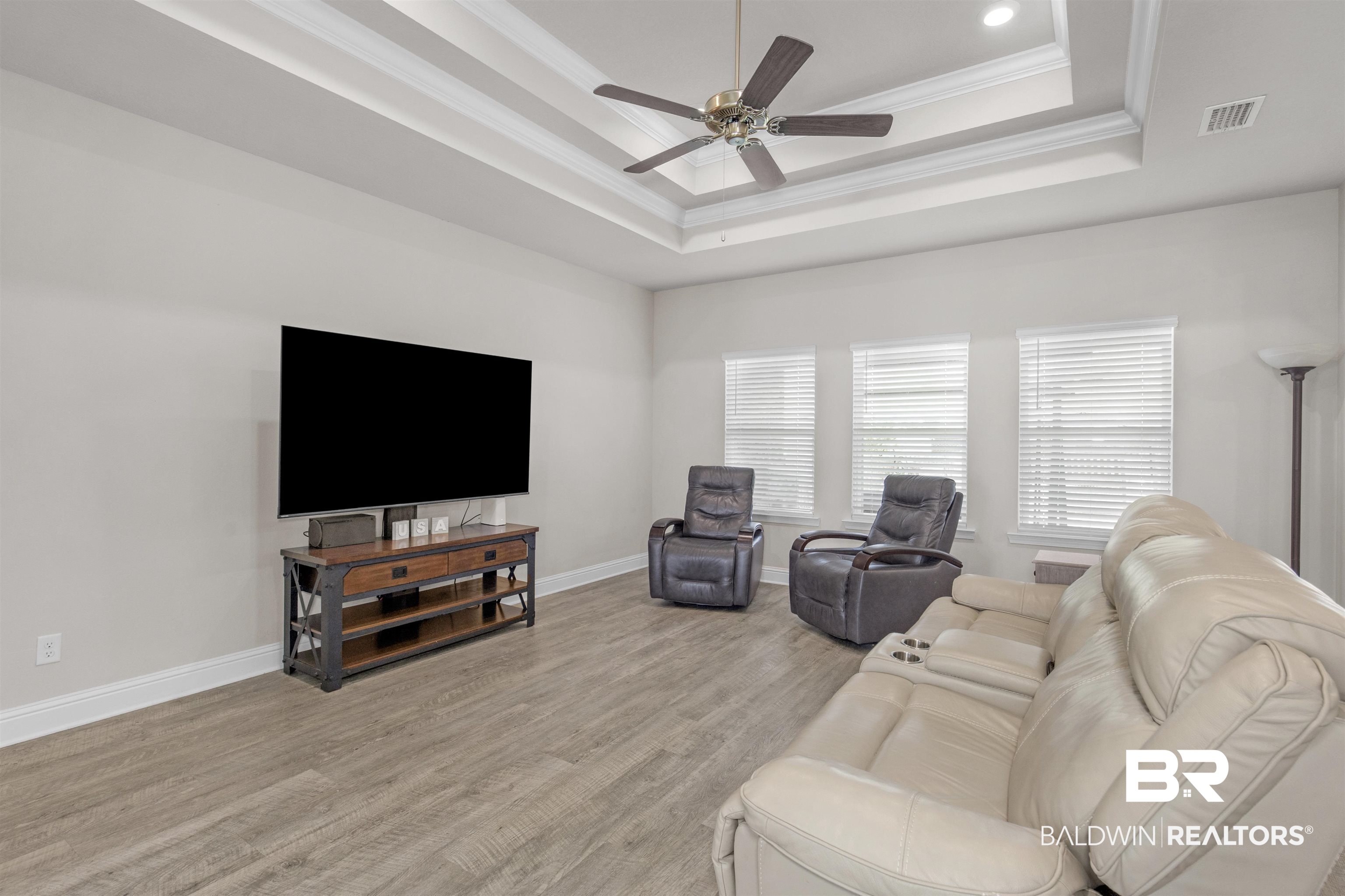 2345 Laurel Street Semmes, AL 36575 - Photo 7 of 31 Living area featuring a tray ceiling, ornamental molding, ceiling fan, light wood finished floors, and recessed lighting