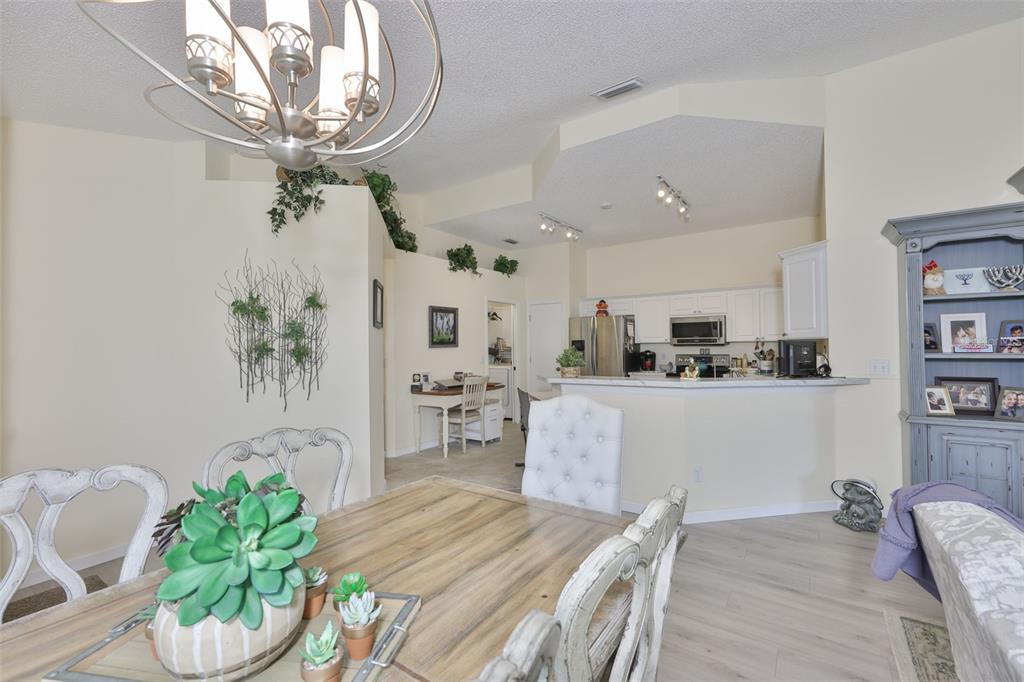 2012 Nantucket Drive, Unit 22 Sun City Center, FL 33573 - Photo 14 of 90 a living room with furniture and a chandelier
