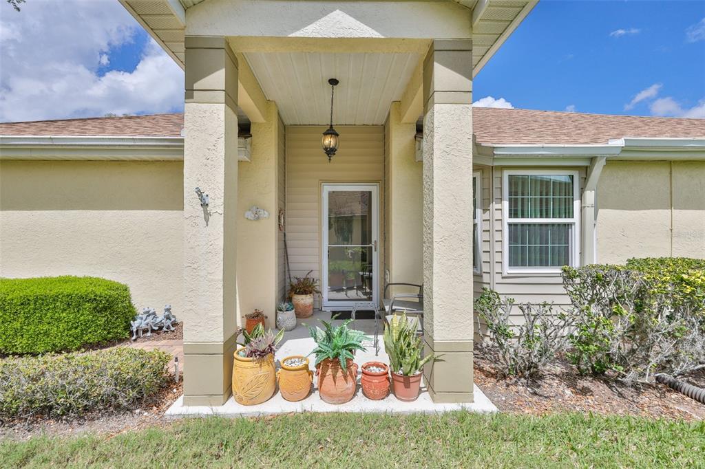 2012 Nantucket Drive, Unit 22 Sun City Center, FL 33573 - Photo 3 of 90 a view of a patio with table and chairs and potted plants