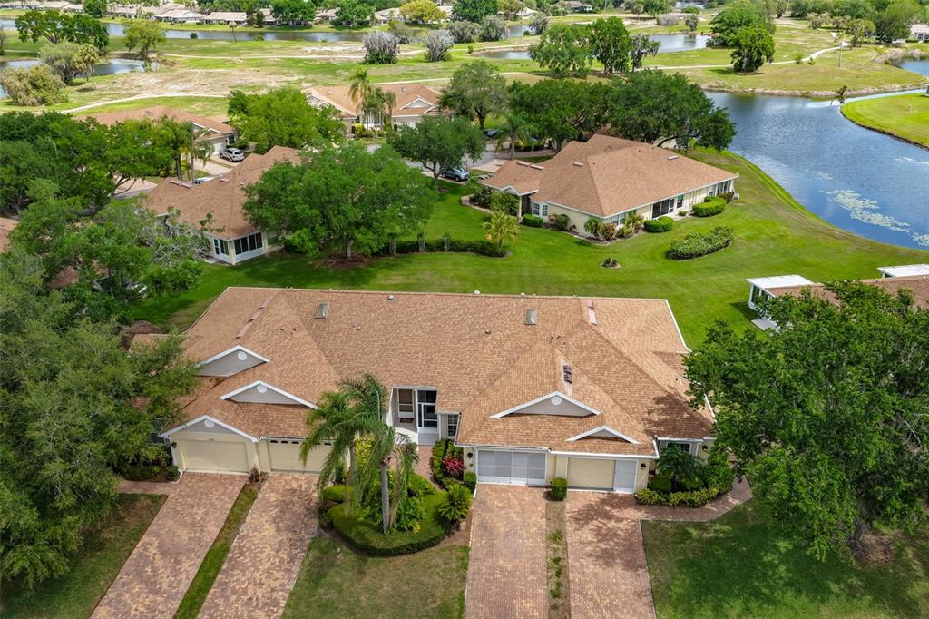 2012 Nantucket Drive, Unit 22 Sun City Center, FL 33573 - Photo 32 of 90 an aerial view of a house with garden space and lake view