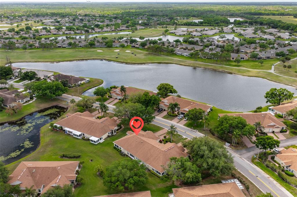 2012 Nantucket Drive, Unit 22 Sun City Center, FL 33573 - Photo 35 of 90 an aerial view of residential houses with outdoor space and lake view